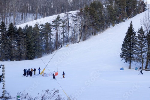 
A sweeping winter landscape stretches across the frame, showcasing a lively Ontario ski resort nestled among snow‑covered evergreens. 