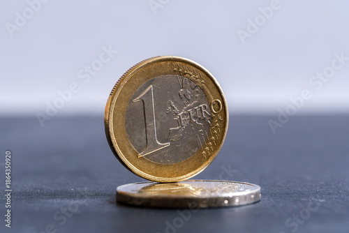 One euro coin standing on stacked coin with copy space, European money and currency concept. Stafford, United Kingdom, January 3, 2026,