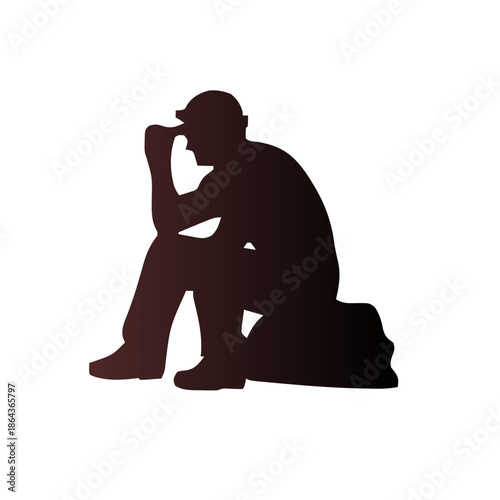 Silhouette of a man sitting on a rock, deep in thought with his hand on his forehead.