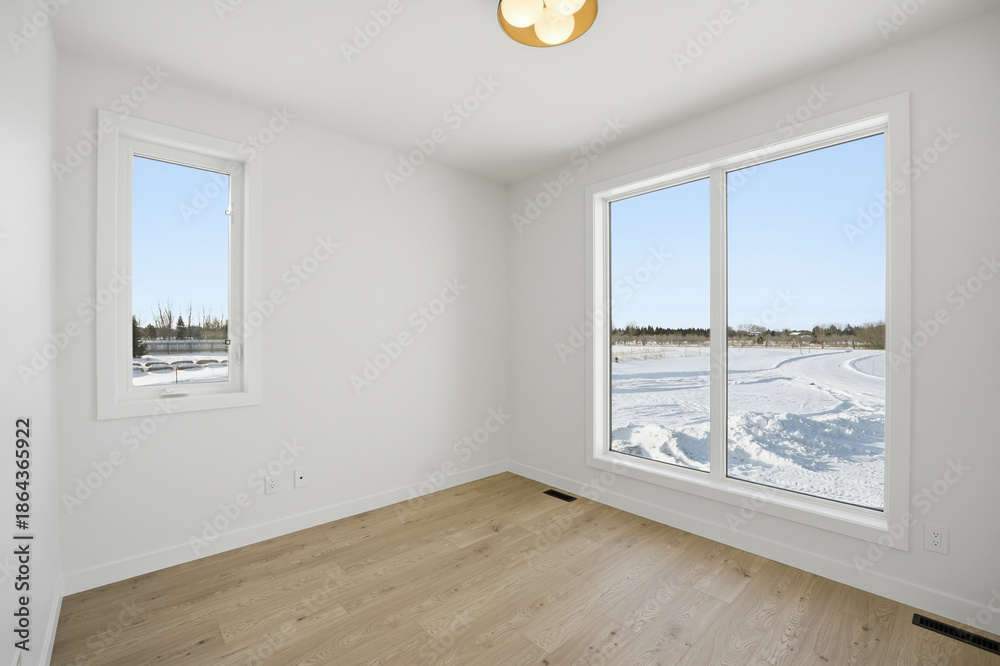 Fototapeta premium Room with a large window overlooking a snowy landscape
