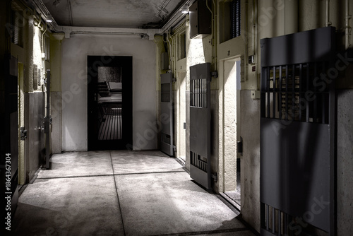 Hong Kong, China. Interior corridor of the former Central Police Station prison at Tai Kwun, showing barred cell doors and the preserved architecture of the detention block.