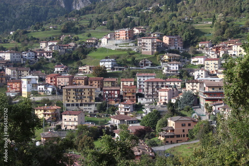 igh-angle panoramic view of the alpine village of Lodrino, situated in the Val Trompia valley, Brescia province. The images capture the traditional Italian mountain architecture, green hillsides