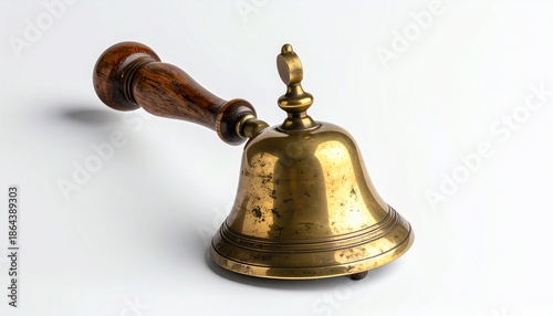 A polished brass bell with a dark wood handle, resting against a white background