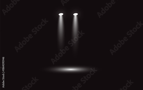 Two spotlight beams shining down on a dark stage