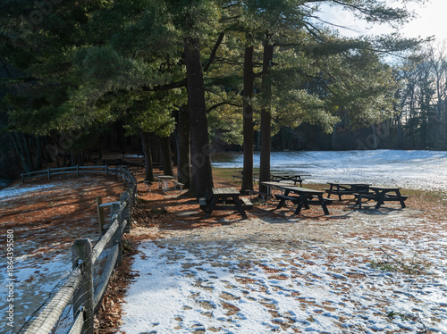 Winter park background showing benches and tables for seating and picnics.