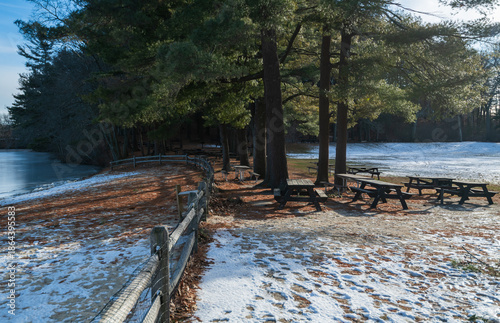Winter park background showing benches and tables for seating and picnics.