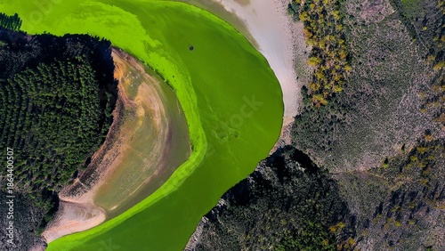 Принти на полотні Drone view of the phosphorescence produced by algae in the Alagon River, Spain
