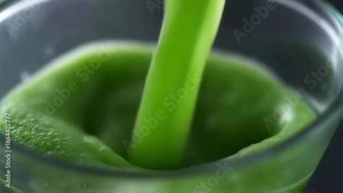 Pouring Green Smoothie into Glass - Healthy Drink Concept.