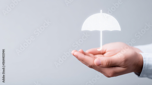 Hands offering glowing insurance umbrella icon symbolizing protection and financial security with soft lighting and neutral background