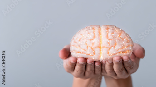 Brain model neural network held in hands glowing connection pattern conveying innovation and care, concept of artificial intelligence and medical research nurturing human cognition