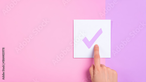 Pink checkmark sticker on pastel background with hand touching approval symbol expressing confirmation and simple minimal concept
