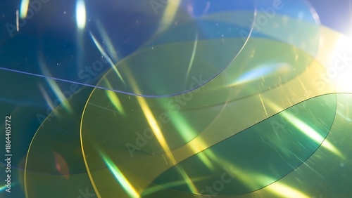 Abstract Geometric Design: An artistic composition of intersecting, translucent shapes, rendered in a palette of blues and greens, creating a sense of depth, movement and visual interest. 