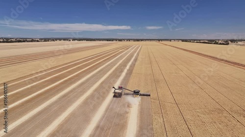 Machinery working in tandem during dry summer harvest