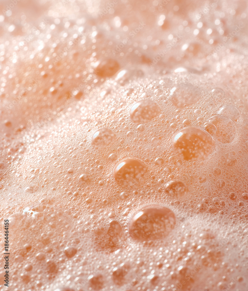 Fototapeta premium Background with macro peach colored foam bubbles creating an abstract pattern 