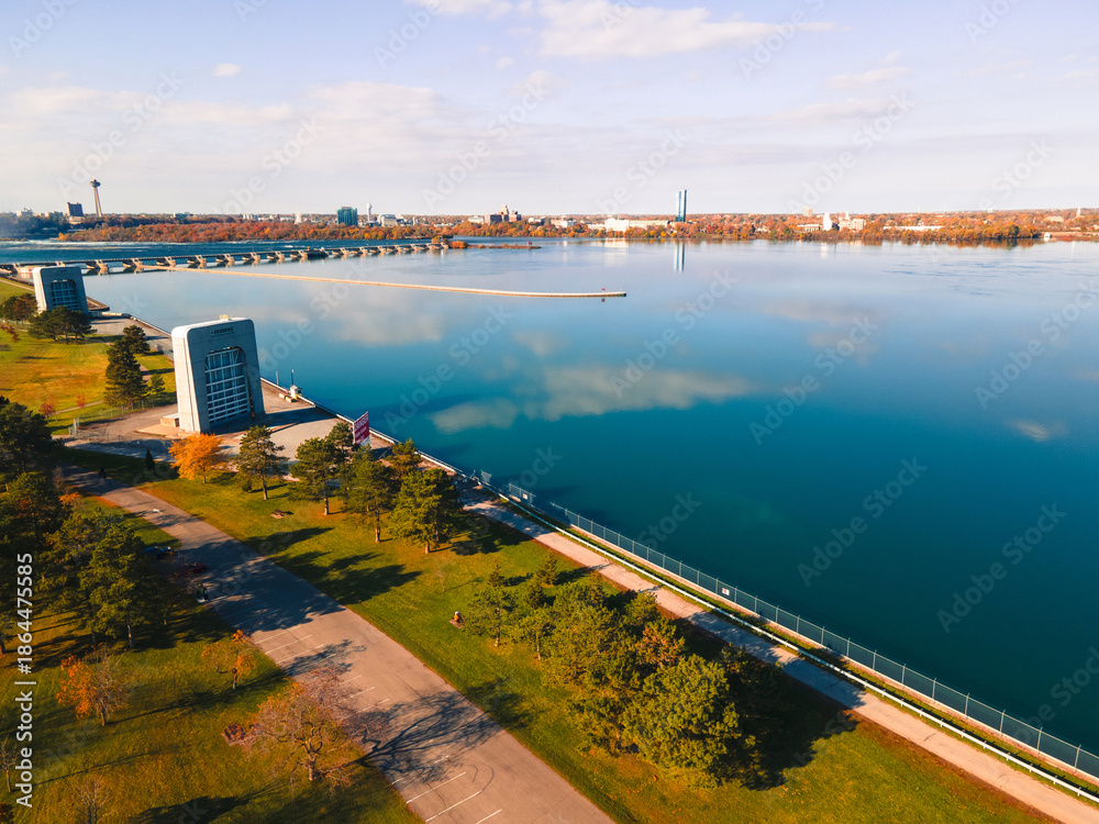Fototapeta premium Aerial view of vibrant autumn foliage near Niagara Falls, Canada. Colorful trees, river, and parkland perfect for travel, nature, and seasonal scenery.