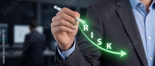 Executive hand drawing a declining risk chart with a glowing green arrow to show financial stability