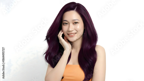Wallpaper Mural Smiling young Asian woman with long wavy dark purple hair wearing an orange top, posing against a white background. Torontodigital.ca