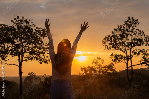 Εκτύπωση καμβά Medium shot Asian female standing against sunset in golden hour on Autumn vacati