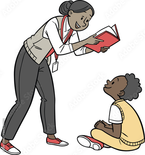 A smiling teacher reads a book to an attentive young student sitting on the floor