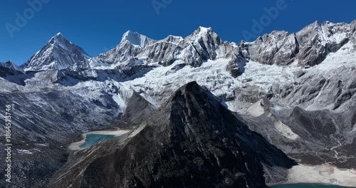 Aerial footage of beautiful snow capped mountain and lake sunrise landscape in Tibet, China