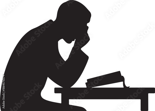 Silhouette of person studying at a desk with books