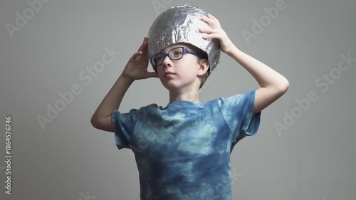 Little boy in glasses takes off homemade space helmet