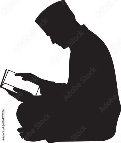 Silhouette of person reading a book while kneeling