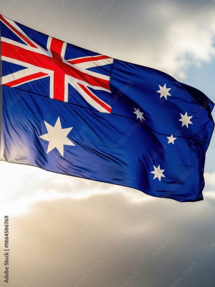 Fototapeta premium Australian Flag Waving Against Blue Sky