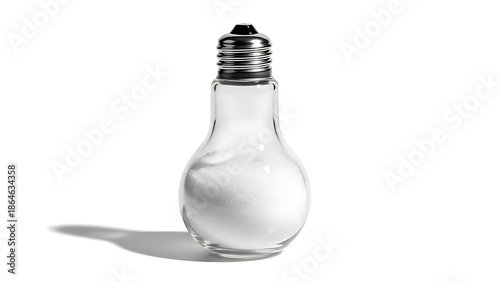 Creative light bulb shaped salt shaker filled with white salt isolated on white background. Novelty glass seasoning dispenser in the form of an electric lightbulb for modern kitchen decor. 