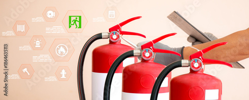 Firefighters are checking red fire extinguisher tank for protection and prevent and safety rescue and use of equipment on fire training concept.