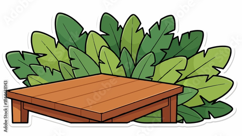 Wooden table in front of lush green tropical leaves