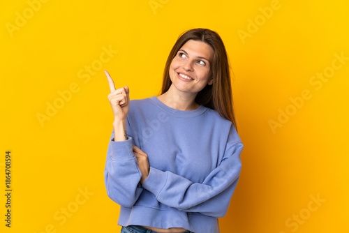 Young Slovak woman isolated on yellow background pointing up a great idea