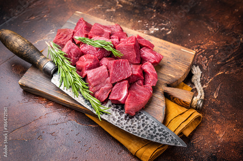 Billede på lærred Diced Raw Venison meat, fresh Wild Roe Deer Game Meat on butcher cutting board