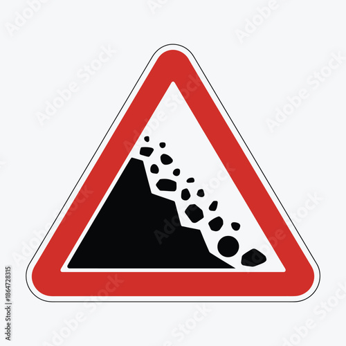Warning sign for loose gravel or rocks on road ahead
