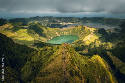 Tableau sur toile Aerial view over the Boca Do Inferno (devil's mouth), at Sete Cidades volcano caldera during sunny day with dramatic sky with green lake Lago Santiago in Sao Miguel, Azores Islands, Portugal