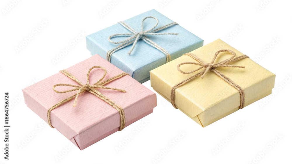 Obraz premium Three small pastel colored jewelry gift boxes tied with rustic twine bows arranged together on transparent background