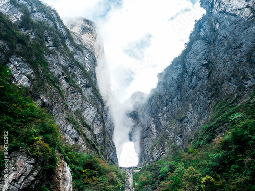 Scenic view amazing of Tianmen Cave, known as Heaven's Gate, surrounded by towering cliffs and mist in Zhangjiajie. A majestic natural wonder and famous travel destination landmark in China.