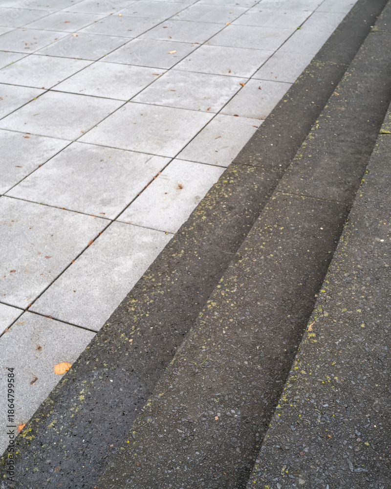 Obraz premium Different textures and materials of a walkway in a modern outdoor space featuring steps and concrete tiles