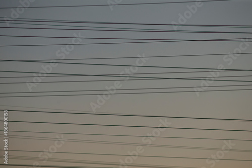 Принти на полотні multiple overhead cables crossing pale sky, dense lines form layered grid above