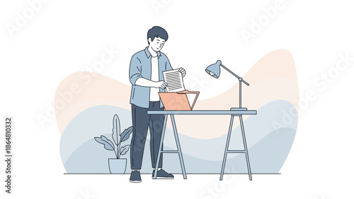 Young man organizing papers and files at a minimalist home office workspace