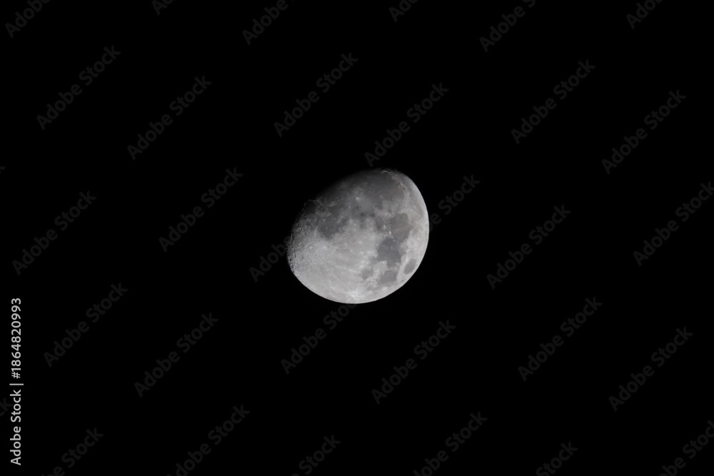 Obraz premium Detailed waxing gibbous moon isolated on a clear black night sky background, showing visible craters, maria and lunar surface texture for astronomy and space concepts.