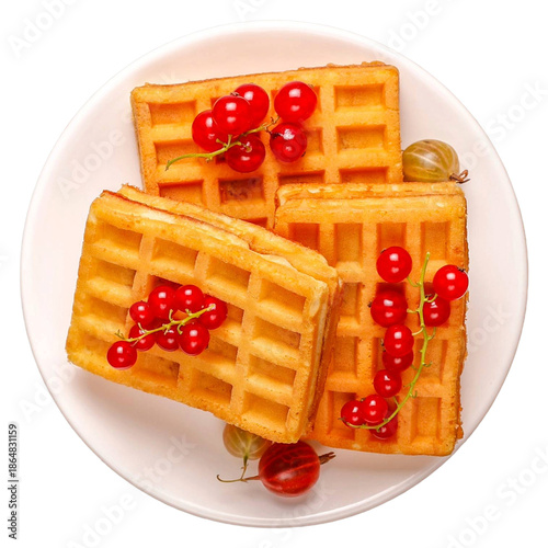 Three waffles topped with red currants on a white plate