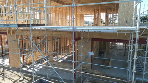 Wooden house frame under construction, timber structure residential building site
