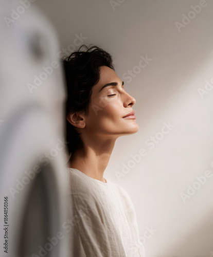 Serene Moment: Woman Practicing Mindfulness and Deep Breathing in a Sunlit Minimalist Room