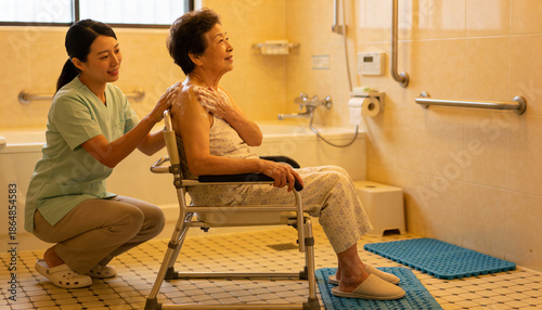 Compassionate caregiver assists elderly woman in bathroom home health setting intimate moment warm environment close-up perspective