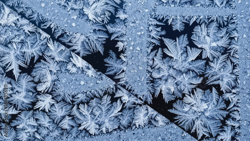 Frozen crystal formations on ice surface, intricate patterns and shapes, frosty blue background, natural winter scenery, cold with snow