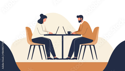 professional business meeting with two people working on laptops sitting at a conference table