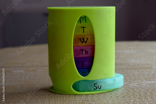 Weekly pill organizer with a variety of medications.