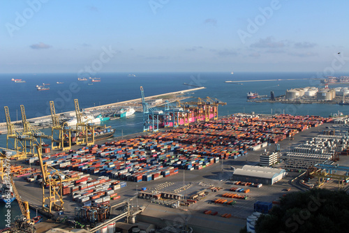 Cruise, cargo ships and container vessels in the busy Port of Barcelona, illustrating maritime trade and industrial activity, taken in July 2024.