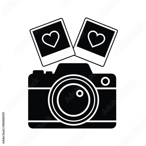Camera with two polaroid photos having heart symbol